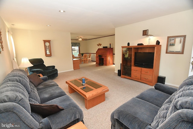 living room with ceiling fan and light colored carpet