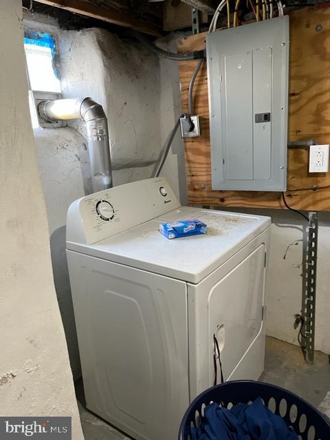 clothes washing area featuring washer / clothes dryer and electric panel