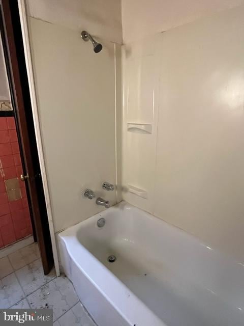 bathroom featuring tile patterned floors and tiled shower / bath