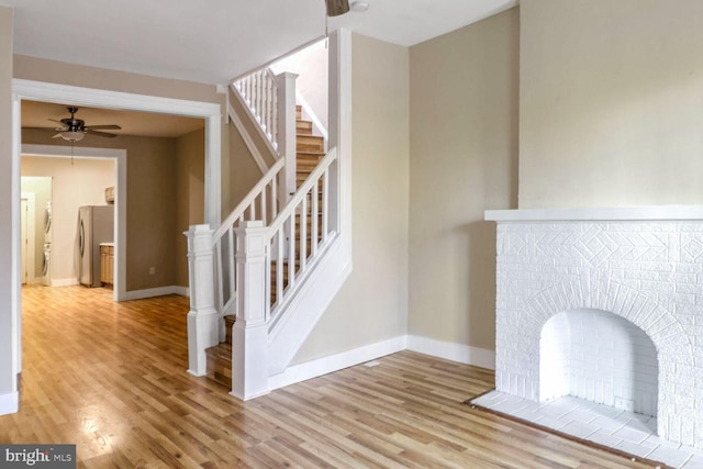 stairs featuring hardwood / wood-style flooring and ceiling fan