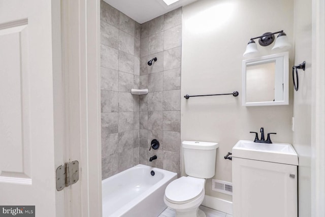 full bathroom featuring vanity, tiled shower / bath combo, and toilet