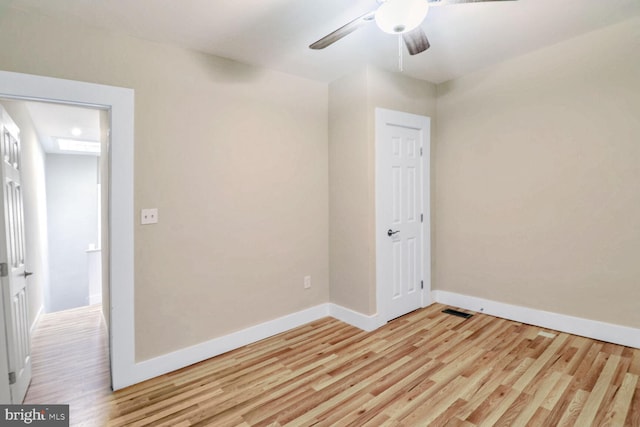 empty room featuring light hardwood / wood-style flooring and ceiling fan