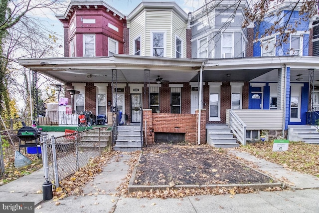 multi unit property featuring ceiling fan and covered porch