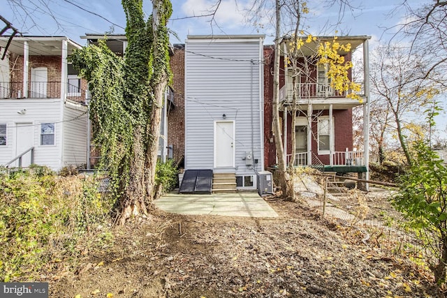 rear view of property with a patio area and a balcony