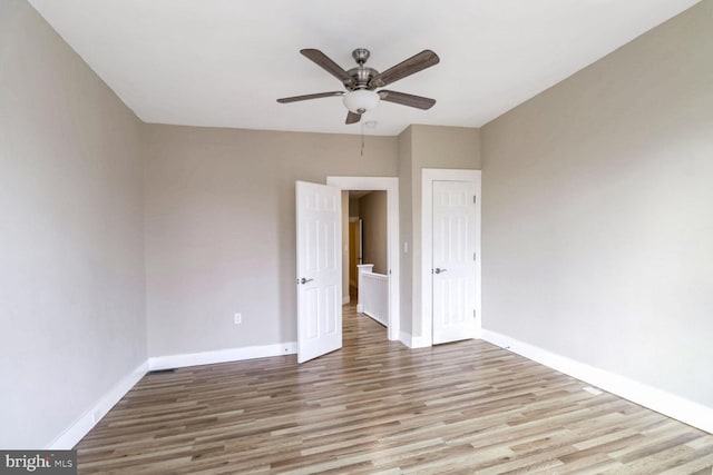 unfurnished bedroom featuring ceiling fan and light wood-type flooring