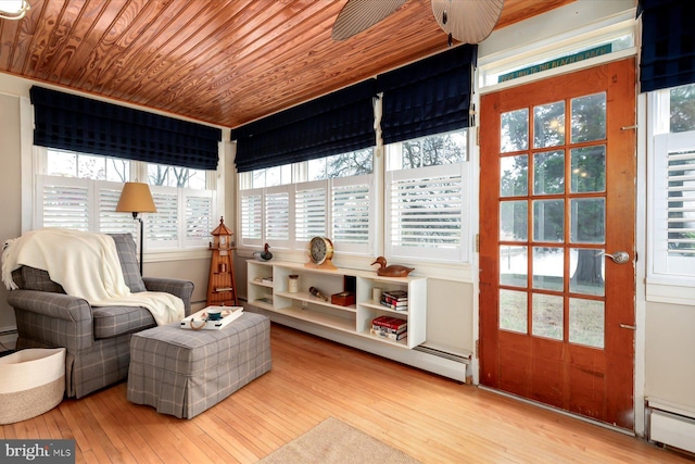 sunroom / solarium with a baseboard heating unit and wooden ceiling