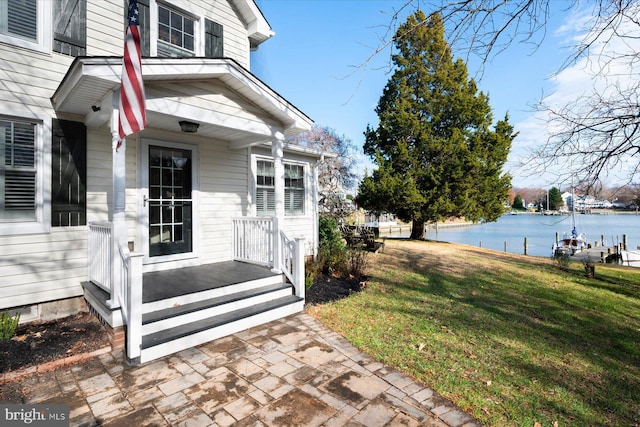 property entrance featuring a water view and a yard