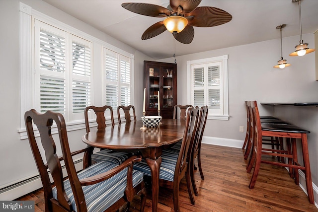 dining area with ceiling fan and dark hardwood / wood-style floors