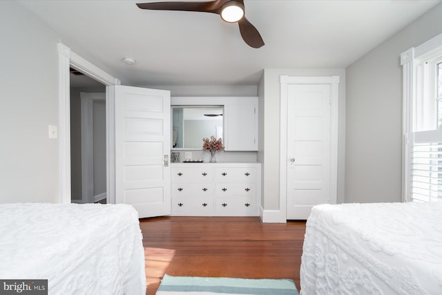 bedroom with dark hardwood / wood-style floors and ceiling fan