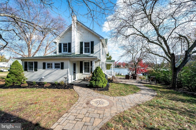 view of front property featuring a front lawn and a patio