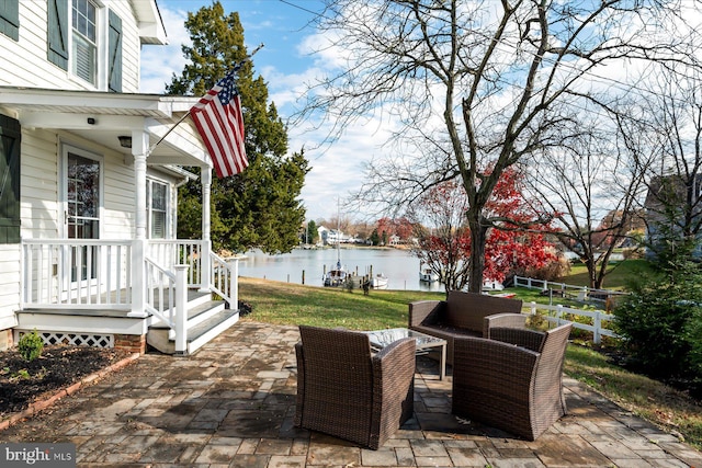 view of patio with outdoor lounge area and a water view