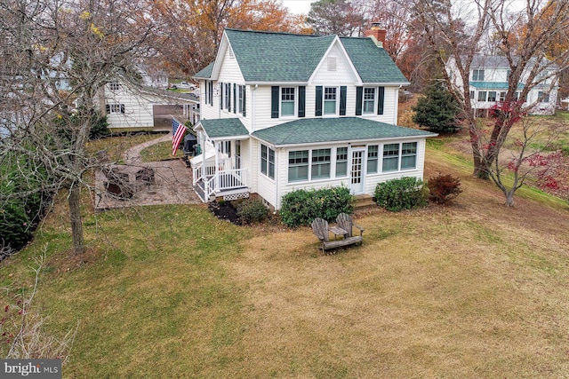 back of property featuring a yard