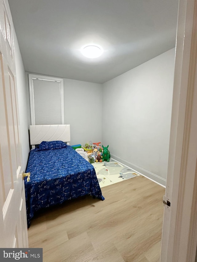 bedroom with wood-type flooring