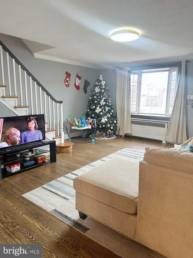 living room featuring hardwood / wood-style floors, a textured ceiling, and radiator