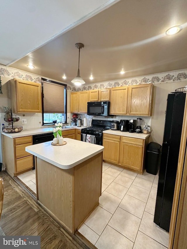 kitchen with tasteful backsplash, black appliances, light tile patterned floors, a center island, and hanging light fixtures