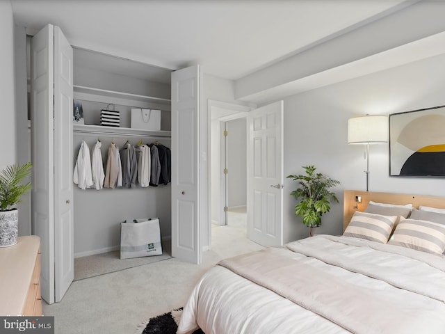 bedroom with light carpet and a closet