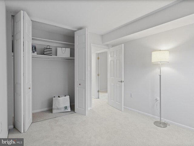 unfurnished bedroom with light colored carpet