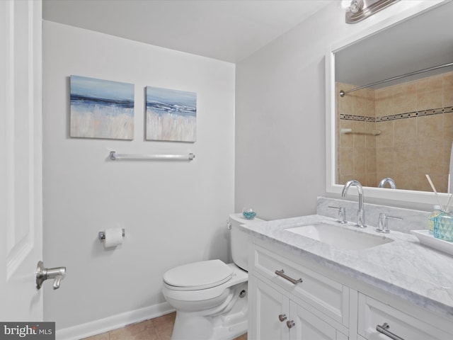 bathroom with tile patterned flooring, vanity, and toilet