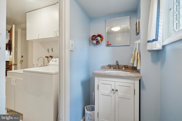 bathroom with washer / clothes dryer and vanity