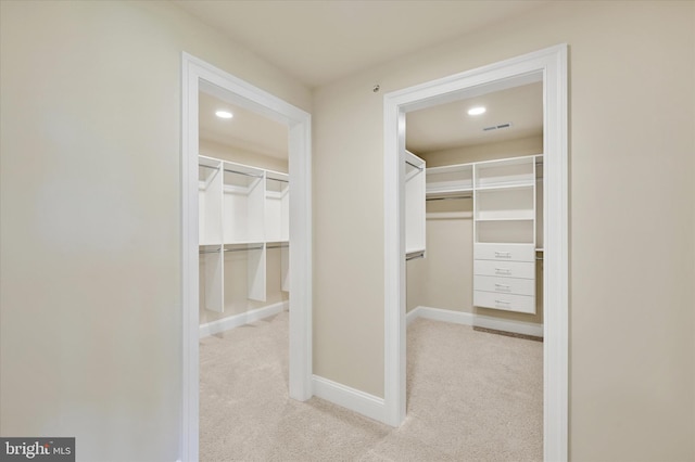 spacious closet featuring light carpet