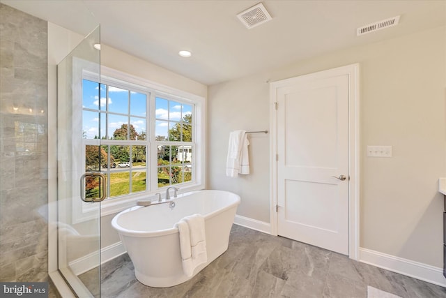 bathroom featuring vanity and independent shower and bath