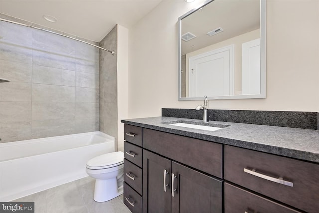 full bathroom featuring tiled shower / bath, tile patterned floors, vanity, and toilet