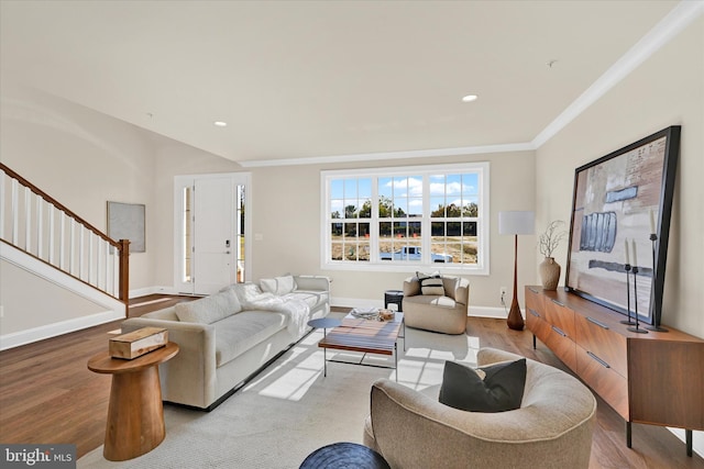 living room featuring light wood-type flooring and ornamental molding