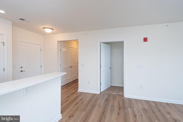 spare room featuring light hardwood / wood-style floors