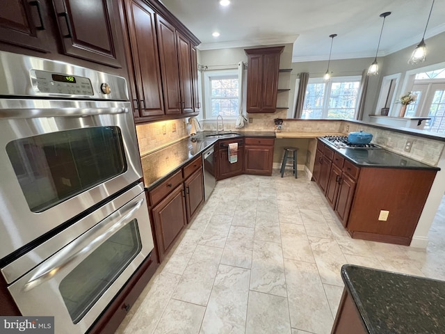 kitchen featuring decorative backsplash, appliances with stainless steel finishes, a peninsula, and ornamental molding