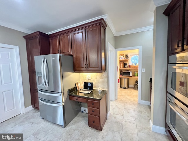 kitchen with ornamental molding, tasteful backsplash, dark stone counters, appliances with stainless steel finishes, and baseboards