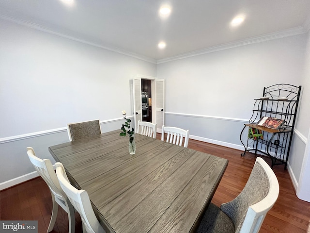 dining space with ornamental molding, baseboards, and wood finished floors