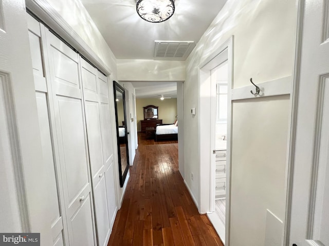 hallway with visible vents and dark wood-style flooring