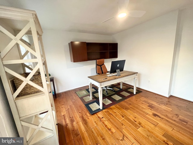 office space featuring baseboards and light wood finished floors