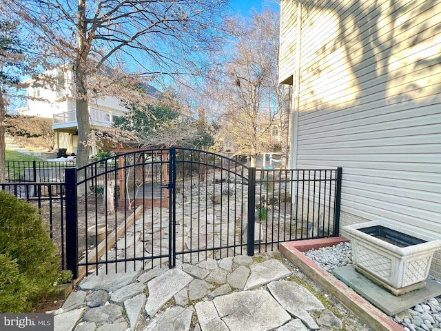 view of gate featuring fence