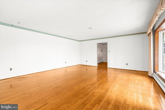 spare room with light hardwood / wood-style floors and a baseboard radiator