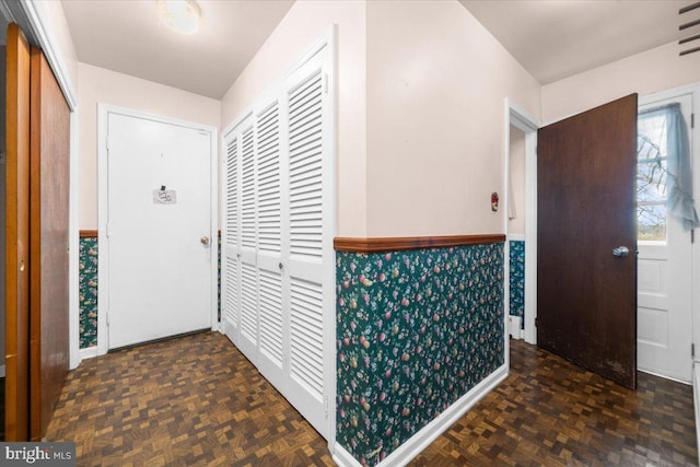 foyer with dark parquet flooring