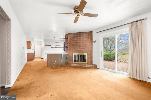 unfurnished living room featuring ceiling fan, a fireplace, and light colored carpet