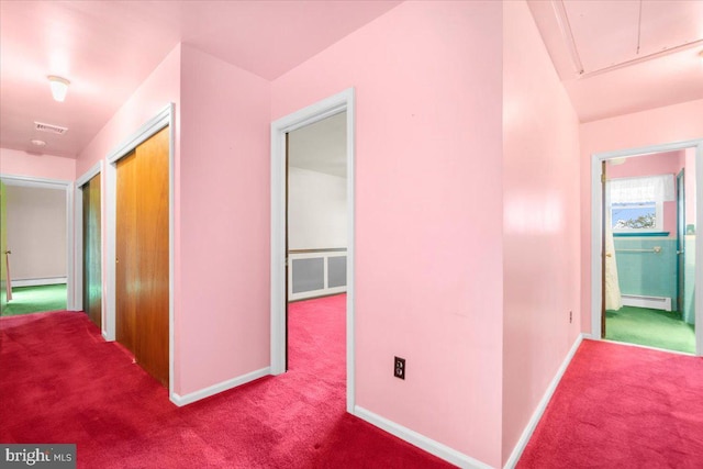 hall with light colored carpet and a baseboard radiator