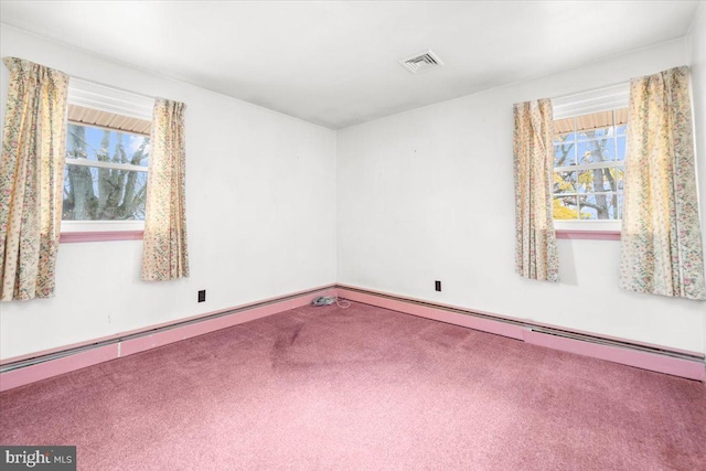 carpeted spare room with a baseboard radiator