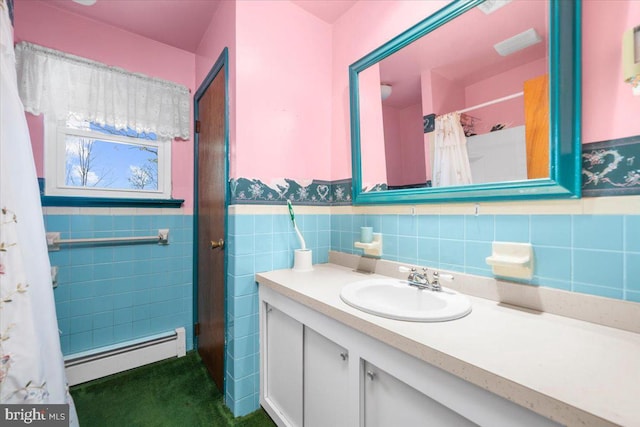 bathroom with vanity, a baseboard radiator, tile walls, and curtained shower