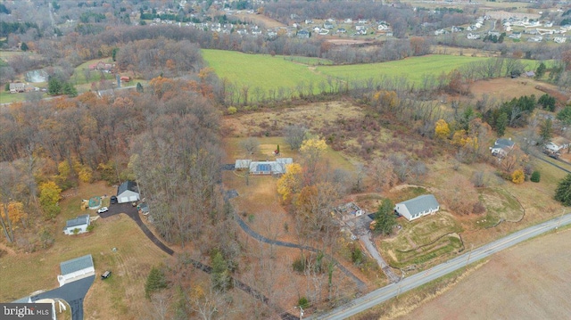 birds eye view of property with a rural view