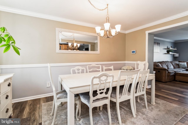 dining space featuring crown molding, a chandelier, and dark hardwood / wood-style floors