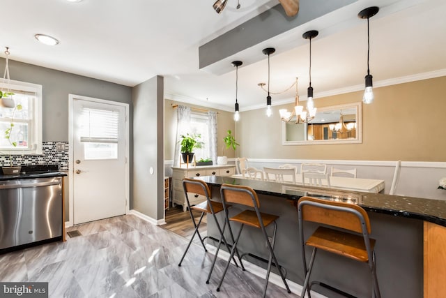 kitchen with dishwasher, pendant lighting, a wealth of natural light, and a breakfast bar area