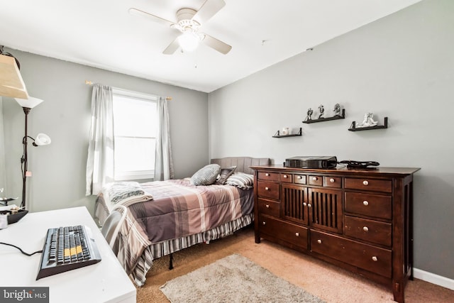 bedroom featuring ceiling fan and light carpet