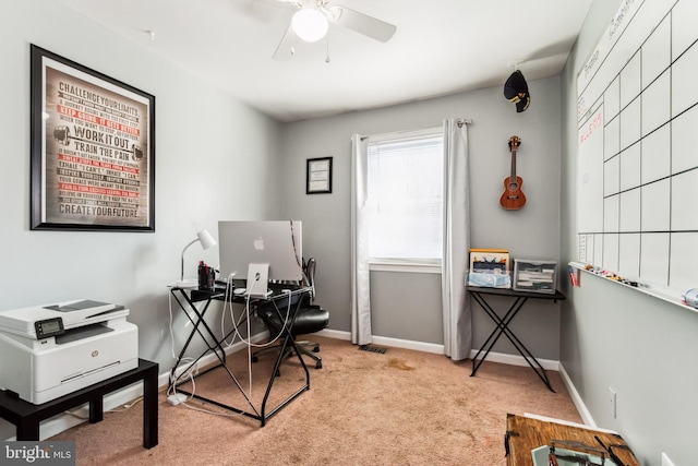 office space featuring light carpet and ceiling fan