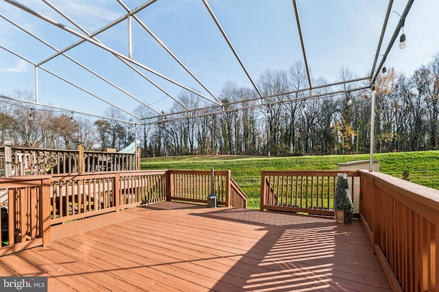 wooden terrace with a lawn