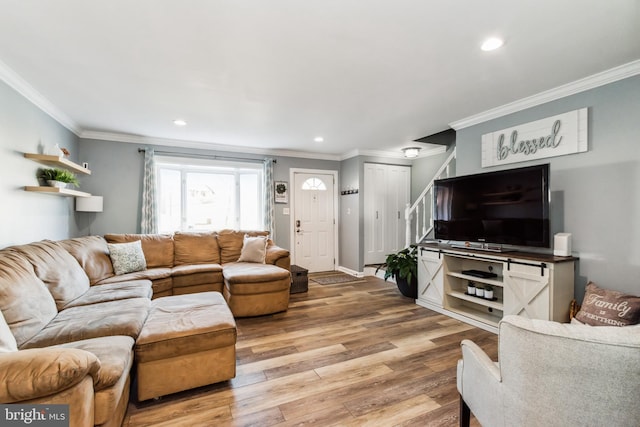 living room with hardwood / wood-style flooring and ornamental molding