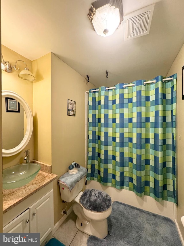 full bathroom featuring tile patterned floors, shower / tub combo with curtain, vanity, and toilet