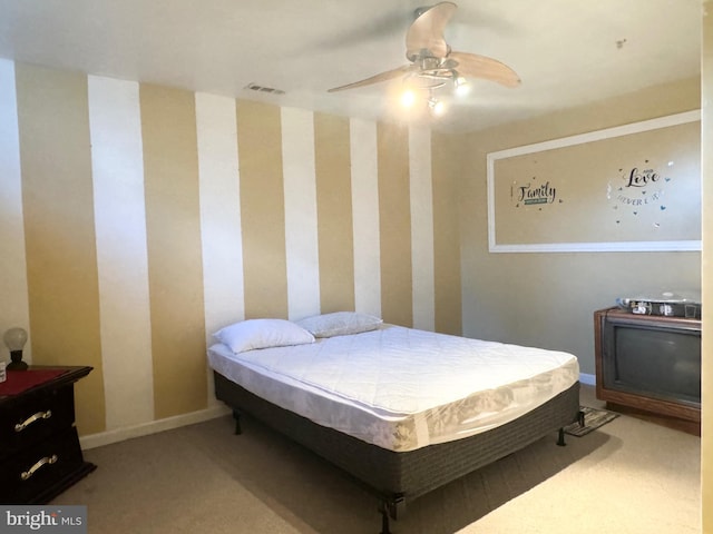 bedroom featuring ceiling fan and light carpet