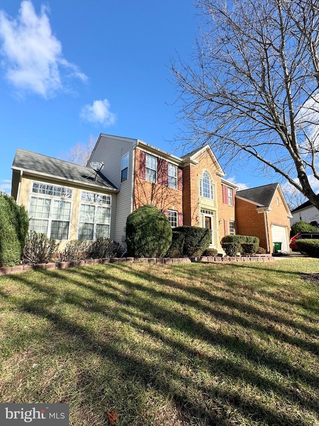 view of front of house with a front lawn and a garage